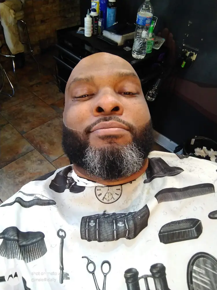 Client in the chair at Horn’s Place with a freshly shaped full beard